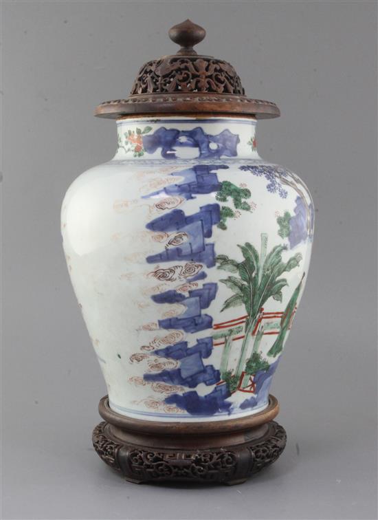 A Chinese wucai baluster jar, Transitional period, 17th century, height 28cm excl. carved hongmu stand and cover